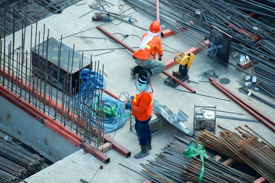 Construction workers preparing materials on an active jobsite